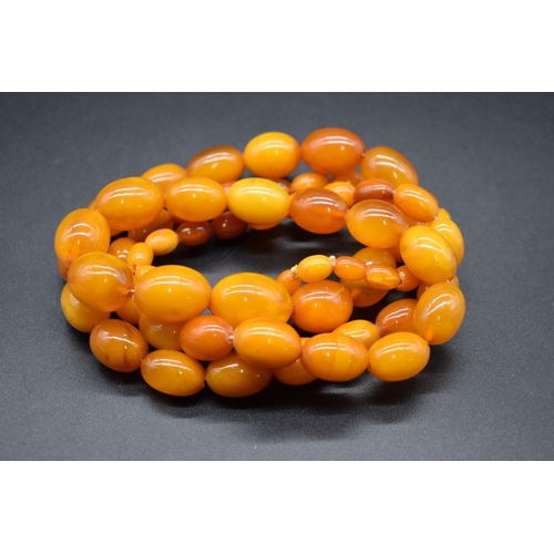 244 - A 'butterscotch' amber graduated bead necklace, 104cm, 102g.