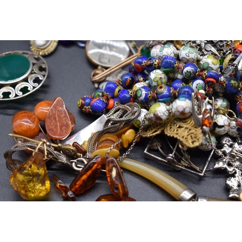 249 - A quantity of costume and silver jewellery; to include an amber bead necklace.