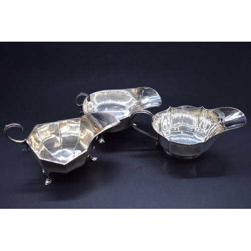 499C - A silver sauce boat, by Horace Woodward & Co Ltd, London 1917; together with two others, 393g. (... 