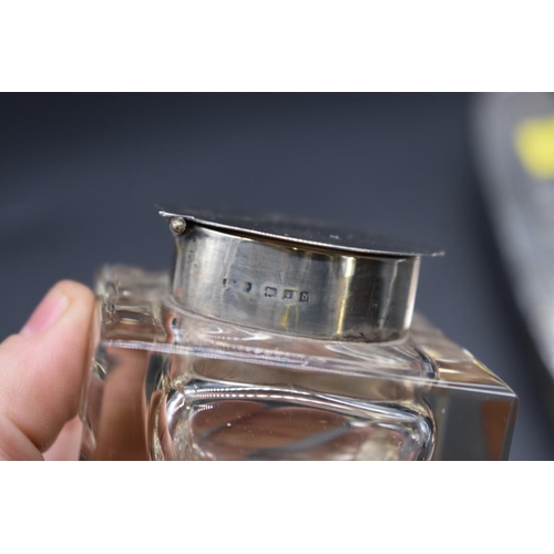 499E - A silver mounted glass inkwell, 6.4cm high; together with an engine turned silver cigarette case; an... 