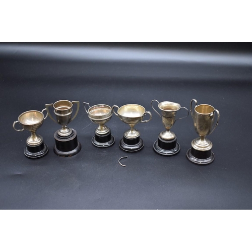 499G - Six miniature silver trophy cups, 157g.