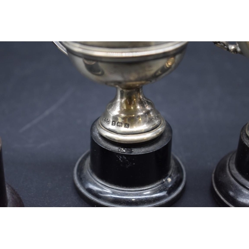 499G - Six miniature silver trophy cups, 157g.