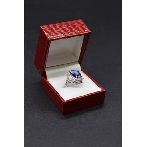 62 - A white and yellow metal cushion cut tanzanite ring, 4.7ct, set with small diamonds, stamped 14k,&nb... 