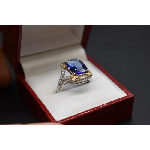 62 - A white and yellow metal cushion cut tanzanite ring, 4.7ct, set with small diamonds, stamped 14k,&nb... 