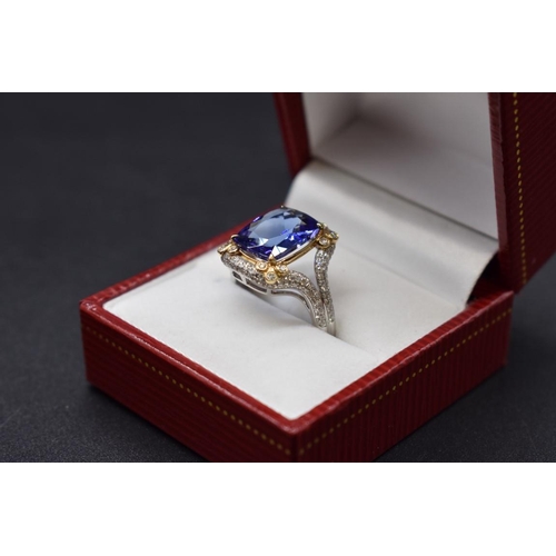 62 - A white and yellow metal cushion cut tanzanite ring, 4.7ct, set with small diamonds, stamped 14k,&nb... 