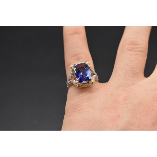 62 - A white and yellow metal cushion cut tanzanite ring, 4.7ct, set with small diamonds, stamped 14k,&nb... 