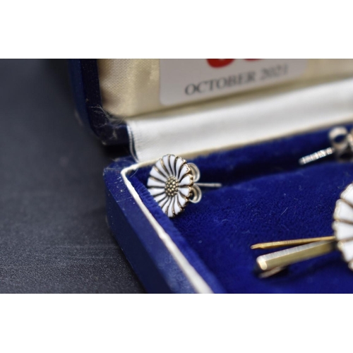 63 - A Danish sterling silver gilt and enamel daisy bar brooch and matching ear studs, by Anton Michelsen... 