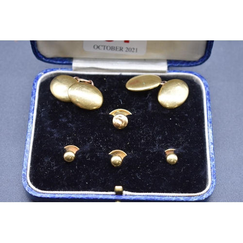 64 - A cased pair of yellow metal cufflinks, stamped 18, 17.5mm, 11.8g; together with three yellow m... 