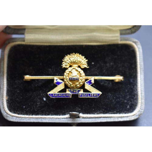 68 - A cased 15ct gold and blue enamel 'The Lancashire Fusiliers' sweetheart bar brooch, 47mm, 5.8g gross... 