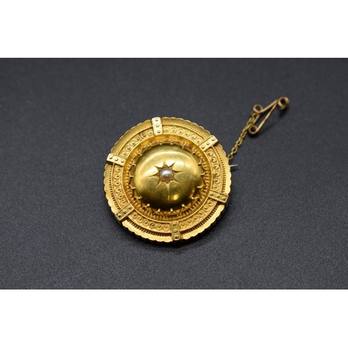 71 - A Victorian yellow metal circular brooch, set central pearl and locket to back, stamped 15ct, 3.2cm.... 