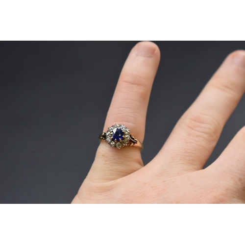 74 - A sapphire and diamond cluster ring, by Jays, stamped 18ct, size M.