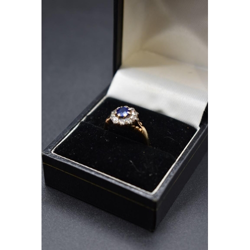 74 - A sapphire and diamond cluster ring, by Jays, stamped 18ct, size M.