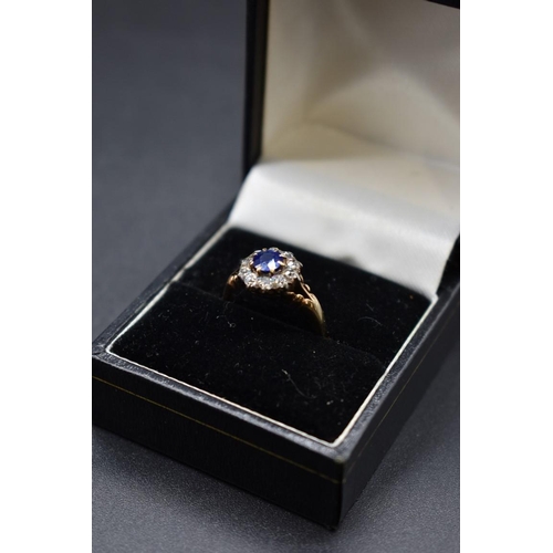 74 - A sapphire and diamond cluster ring, by Jays, stamped 18ct, size M.