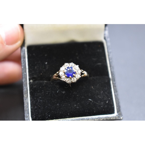 74 - A sapphire and diamond cluster ring, by Jays, stamped 18ct, size M.