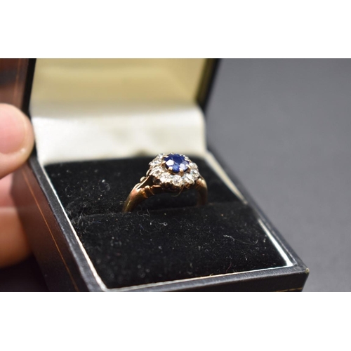 74 - A sapphire and diamond cluster ring, by Jays, stamped 18ct, size M.