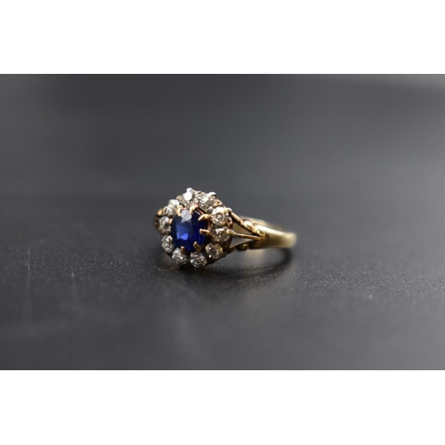 74 - A sapphire and diamond cluster ring, by Jays, stamped 18ct, size M.