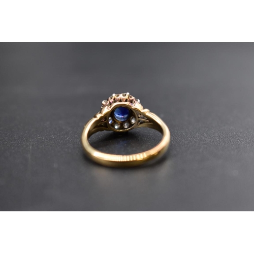 74 - A sapphire and diamond cluster ring, by Jays, stamped 18ct, size M.