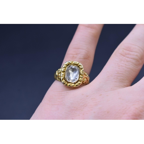 75 - An antique yellow metal ring, set faceted quartz, size Q.