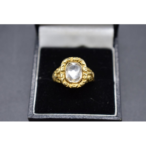 75 - An antique yellow metal ring, set faceted quartz, size Q.