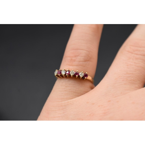 78 - A yellow metal ruby and diamond eight stone ring, stamped 14k 585, size N, 2.3g gross weight.... 