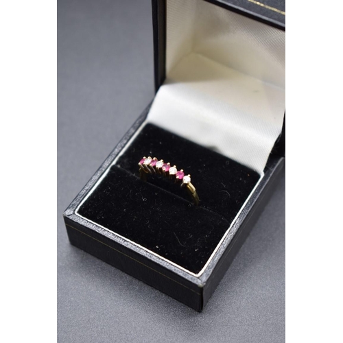 78 - A yellow metal ruby and diamond eight stone ring, stamped 14k 585, size N, 2.3g gross weight.... 