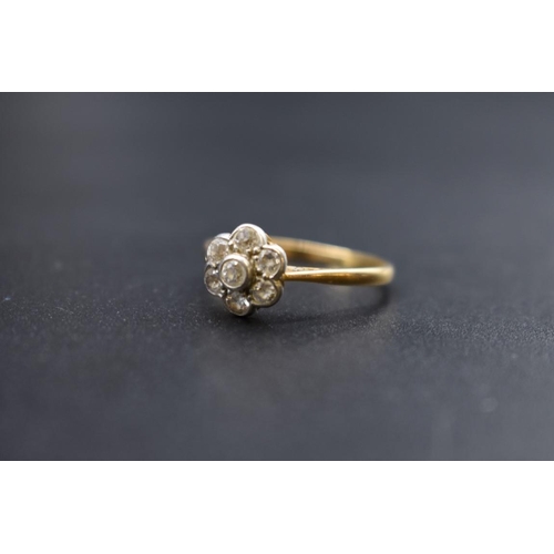 79 - A yellow metal diamond daisy cluster ring, stamped 18ct Plat, Size S, 2.7g.