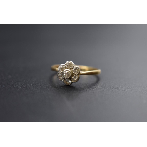 79 - A yellow metal diamond daisy cluster ring, stamped 18ct Plat, Size S, 2.7g.