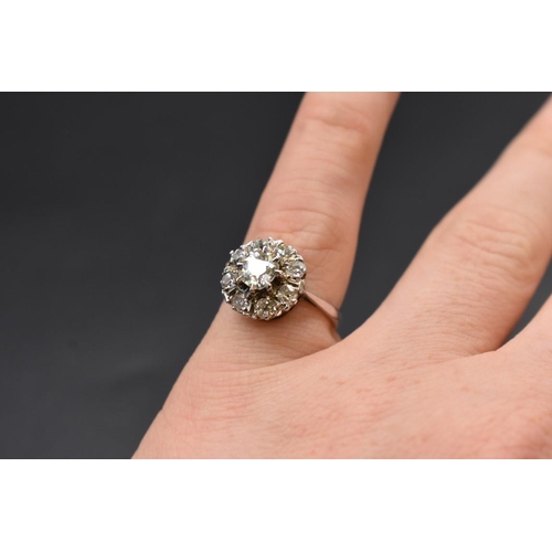 80 - An Edwardian diamond cluster ring, set to centre with a cushion shape old cut diamond of approximate... 