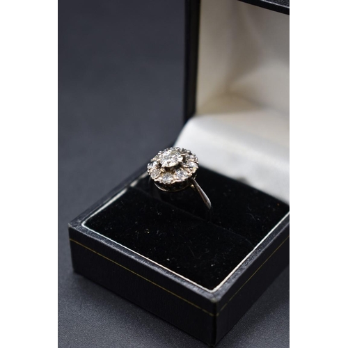 80 - An Edwardian diamond cluster ring, set to centre with a cushion shape old cut diamond of approximate... 