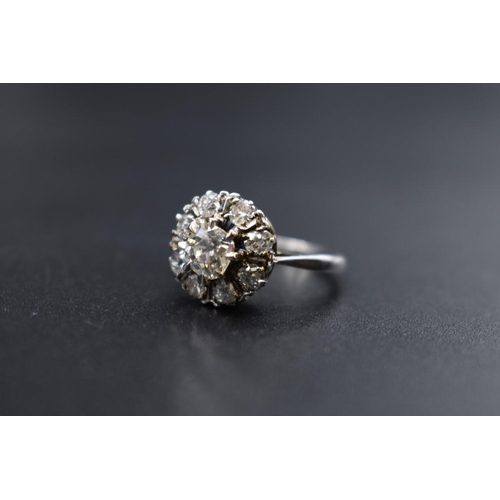 80 - An Edwardian diamond cluster ring, set to centre with a cushion shape old cut diamond of approximate... 