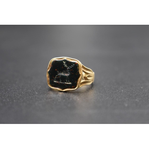 90 - An antique yellow metal ring, set intaglio carved bloodstone of a stag, size F 1/2.