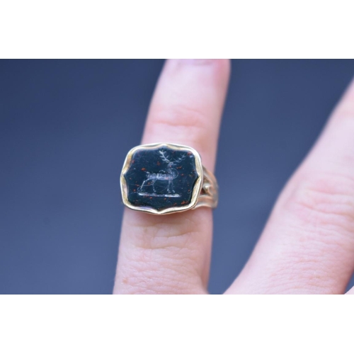 90 - An antique yellow metal ring, set intaglio carved bloodstone of a stag, size F 1/2.