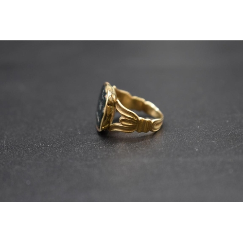 90 - An antique yellow metal ring, set intaglio carved bloodstone of a stag, size F 1/2.