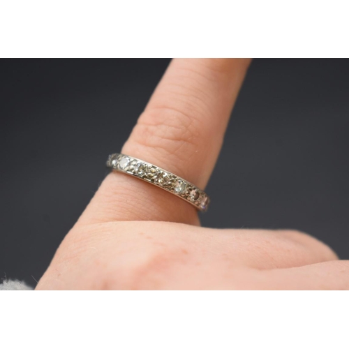 91 - A white metal diamond eternity ring, size O 1/2, gross weight 4g.