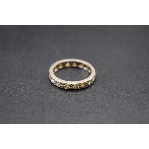 91 - A white metal diamond eternity ring, size O 1/2, gross weight 4g.