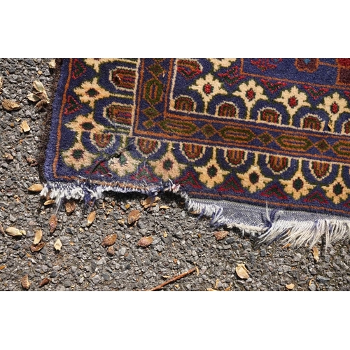 1105a - A Persian rug,&nbsp;central field decorated with two urns and flowers, 200 x 113cm.