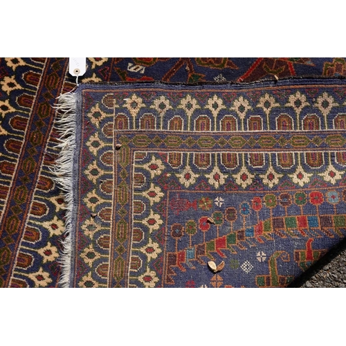 1105a - A Persian rug,&nbsp;central field decorated with two urns and flowers, 200 x 113cm.