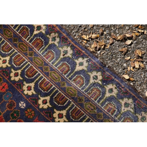 1105a - A Persian rug,&nbsp;central field decorated with two urns and flowers, 200 x 113cm.