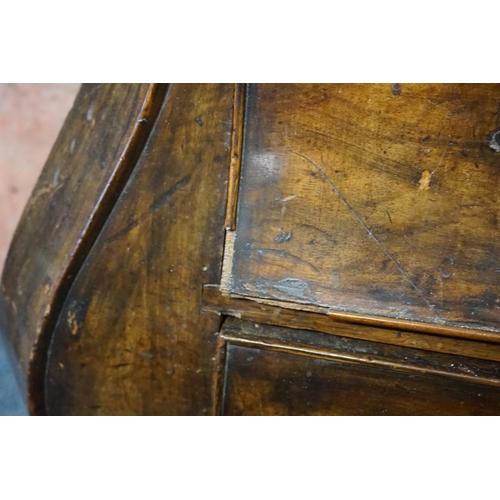 1396 - From Arundel Castle: an 18th century Dutch walnut bombe commode, with shaped top above four gra... 