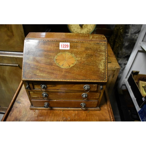 1229 - A miniature mahogany and inlaid bureau, 26.5cm wide; together with another early 20th century oak ta... 