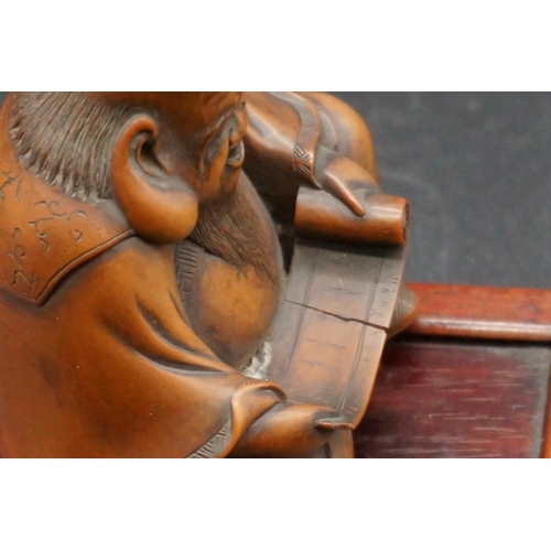 1290 - A good Japanese carved wood figure of a seated immortal, possibly Fukurokuju, Meiji, holding a scrol... 