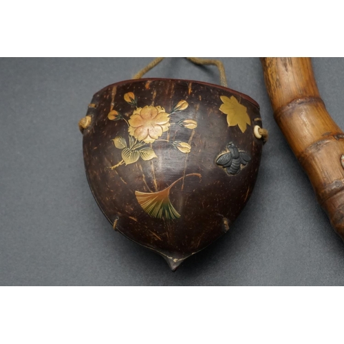 1293 - A Japanese bamboo kiseruzutsu and seed pod tonkotsu, 19th century, the tobacco box decorated with gi... 