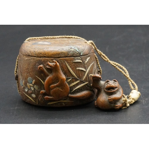 1295 - A good Japanese wood and inlaid tonkotsu, Edo, signed, 9cm wide; with attached monkey netsuke, signe... 