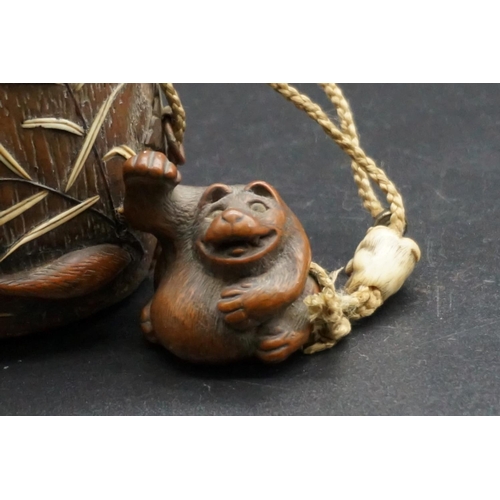 1295 - A good Japanese wood and inlaid tonkotsu, Edo, signed, 9cm wide; with attached monkey netsuke, signe... 