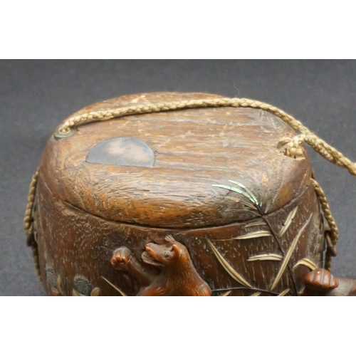 1295 - A good Japanese wood and inlaid tonkotsu, Edo, signed, 9cm wide; with attached monkey netsuke, signe... 