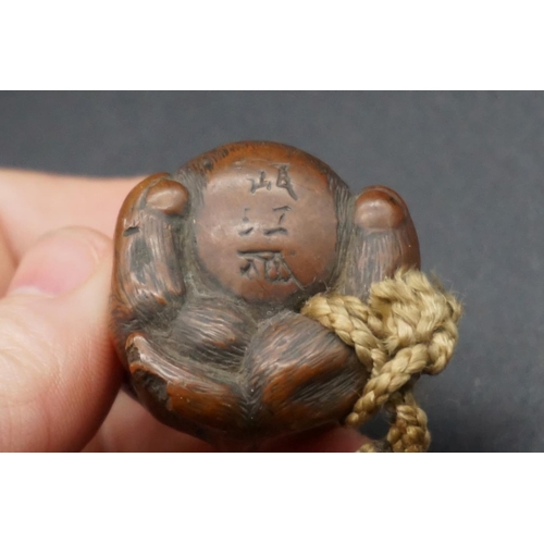 1295 - A good Japanese wood and inlaid tonkotsu, Edo, signed, 9cm wide; with attached monkey netsuke, signe... 