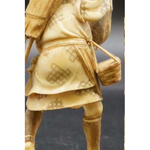 1296 - A Japanese carved ivory okimono, Meiji, depicting a crab fisherman, signed, 16.5cm high, (s.d.).... 