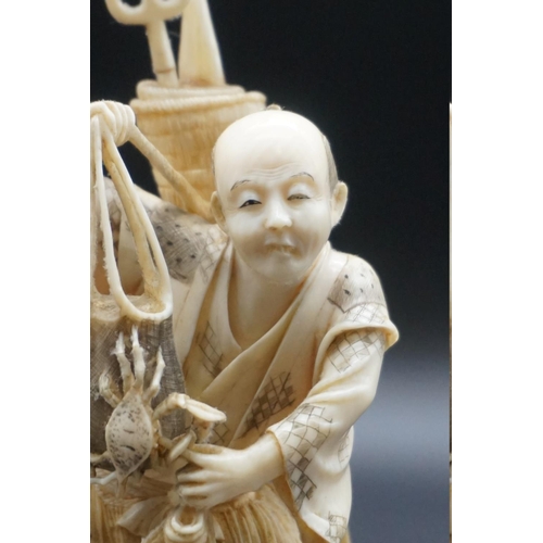 1296 - A Japanese carved ivory okimono, Meiji, depicting a crab fisherman, signed, 16.5cm high, (s.d.).... 