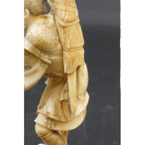 1296 - A Japanese carved ivory okimono, Meiji, depicting a crab fisherman, signed, 16.5cm high, (s.d.).... 