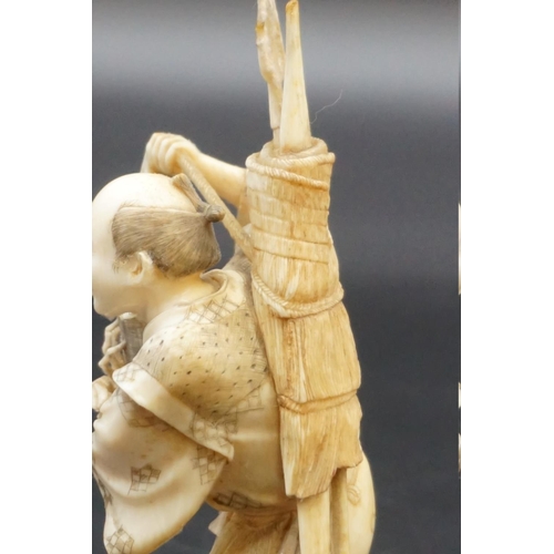 1296 - A Japanese carved ivory okimono, Meiji, depicting a crab fisherman, signed, 16.5cm high, (s.d.).... 